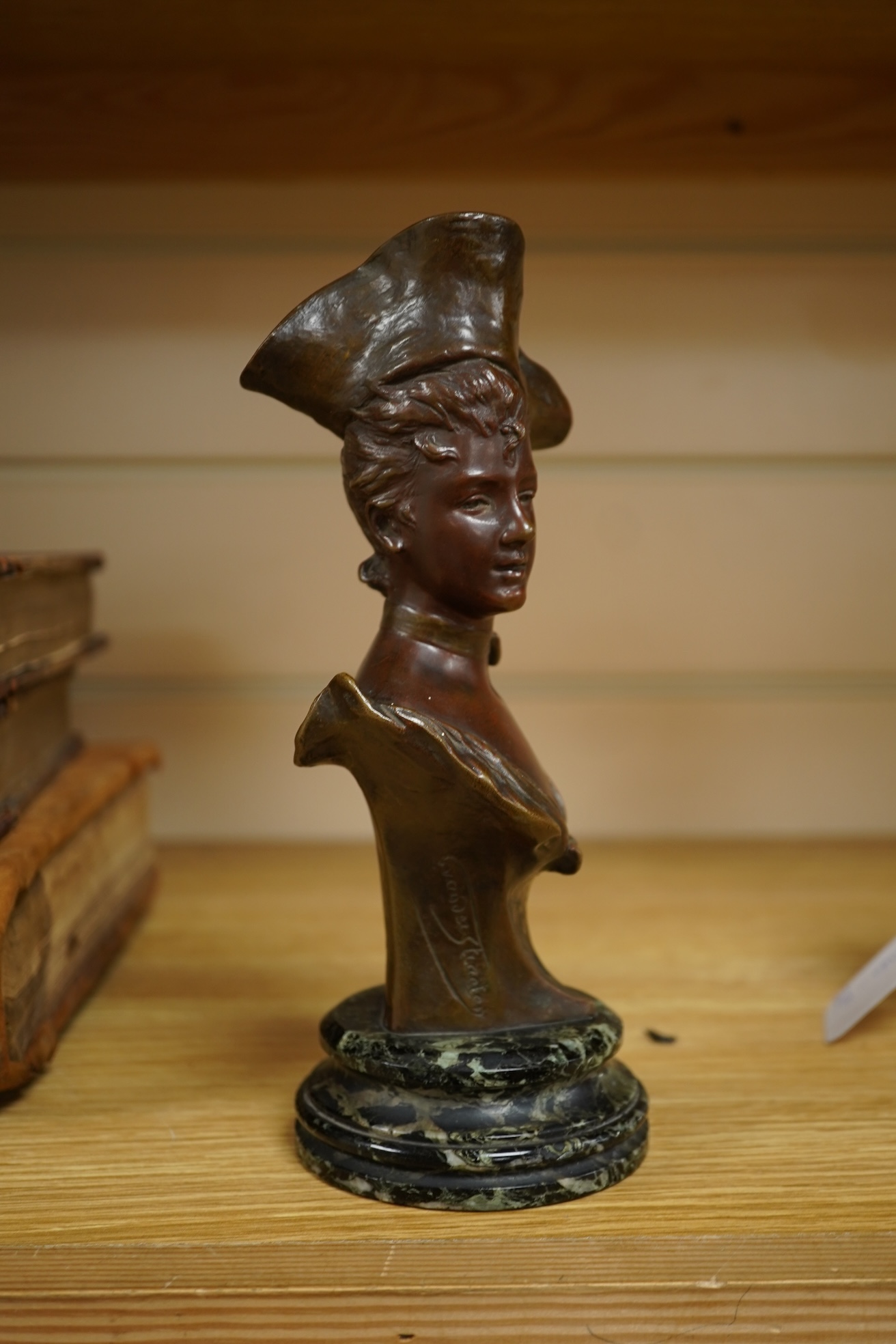 George Van Der Straeten (Belgium, 1856-1928) A bronze bust of a lady wearing a hat, signed, mounted on marble base, 21.5cm high